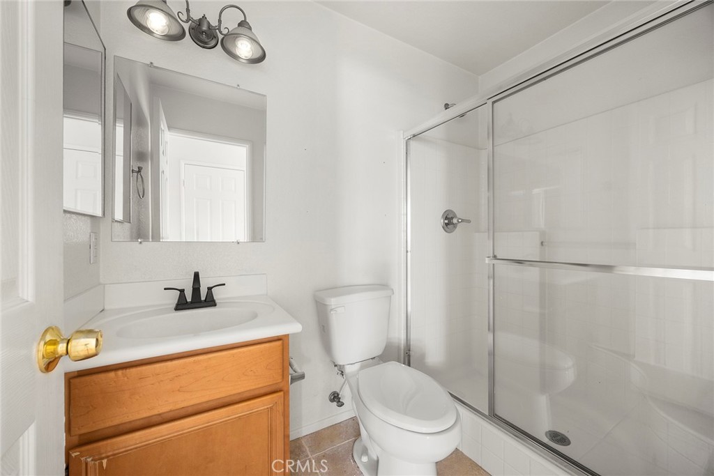 12351 Mesa Grove Drive Riverside, CA 92503 - Photo 17 of 32 a bathroom with a sink a toilet and shower