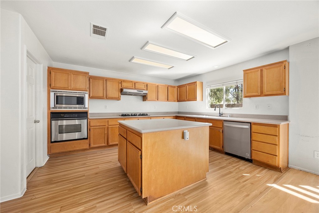 12351 Mesa Grove Drive Riverside, CA 92503 - Photo 10 of 32 a kitchen with stainless steel appliances granite countertop a stove and a refrigerator
