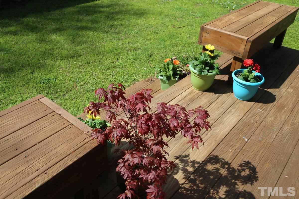 2748 Layden Street Raleigh, NC 27603 - Photo 3 of 25 a view of a backyard with a garden and flowers