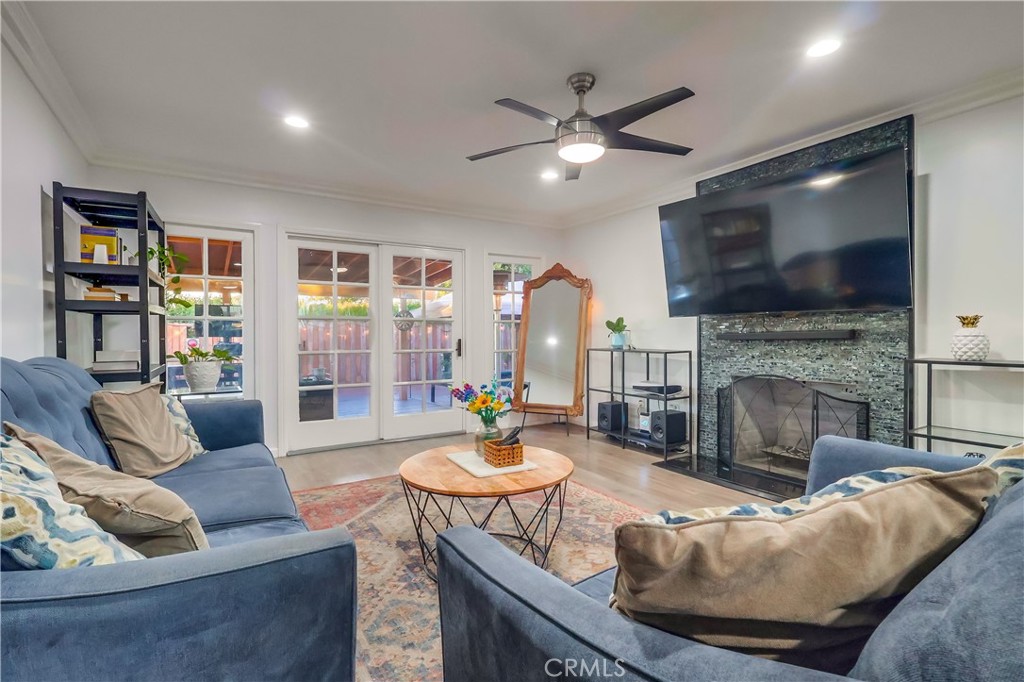 10937 Colima Road Whittier, CA 90604 - Photo 13 of 55 a living room with furniture a fireplace and a flat screen tv