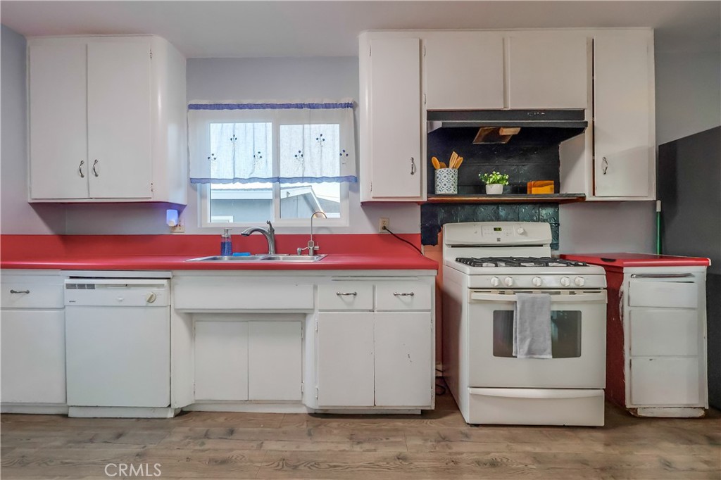 10937 Colima Road Whittier, CA 90604 - Photo 21 of 55 a kitchen with a stove and white cabinets