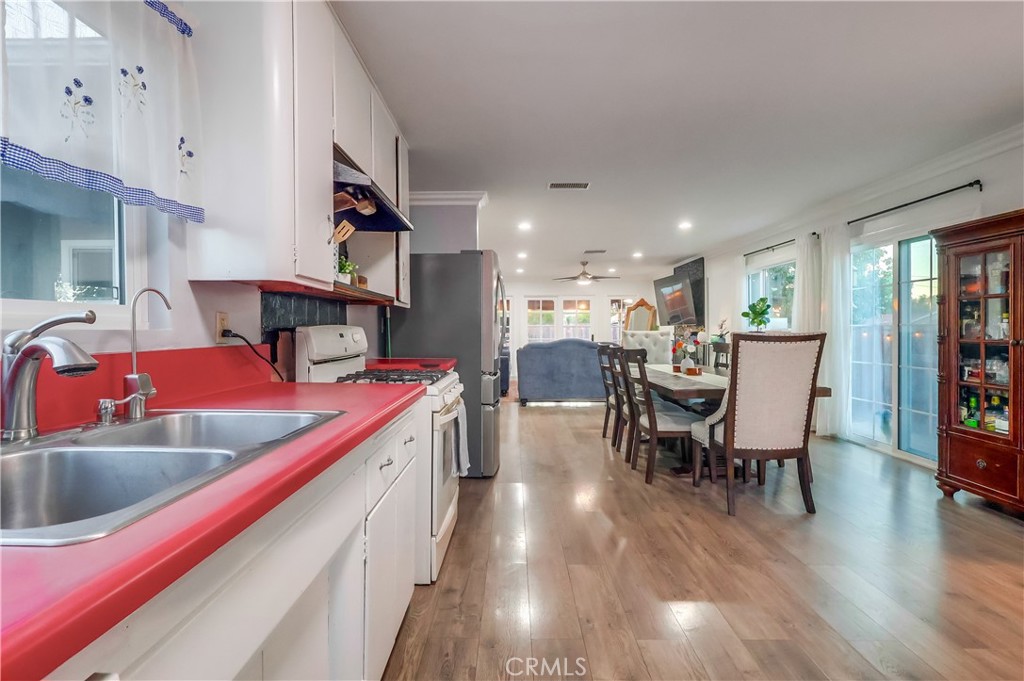 10937 Colima Road Whittier, CA 90604 - Photo 22 of 55 a kitchen with stainless steel appliances kitchen island granite countertop a sink and wooden floors