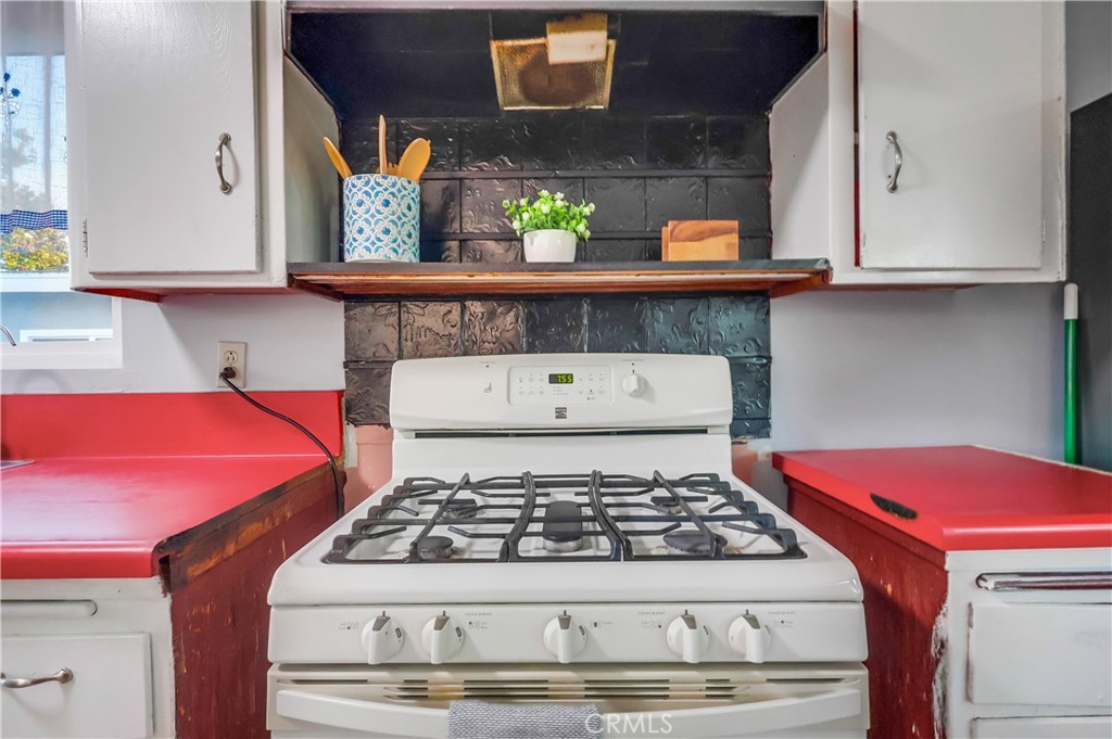 10937 Colima Road Whittier, CA 90604 - Photo 23 of 55 a kitchen with stainless steel appliances granite countertop a stove a microwave and cabinets