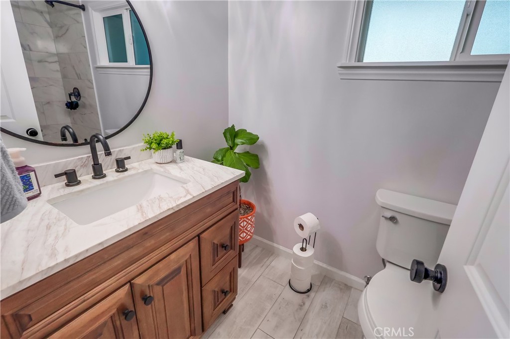 10937 Colima Road Whittier, CA 90604 - Photo 28 of 55 a bathroom with a sink toilet and mirror