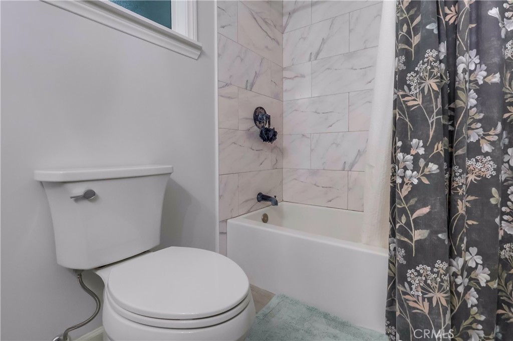 10937 Colima Road Whittier, CA 90604 - Photo 29 of 55 a white toilet sitting next to a bath tub