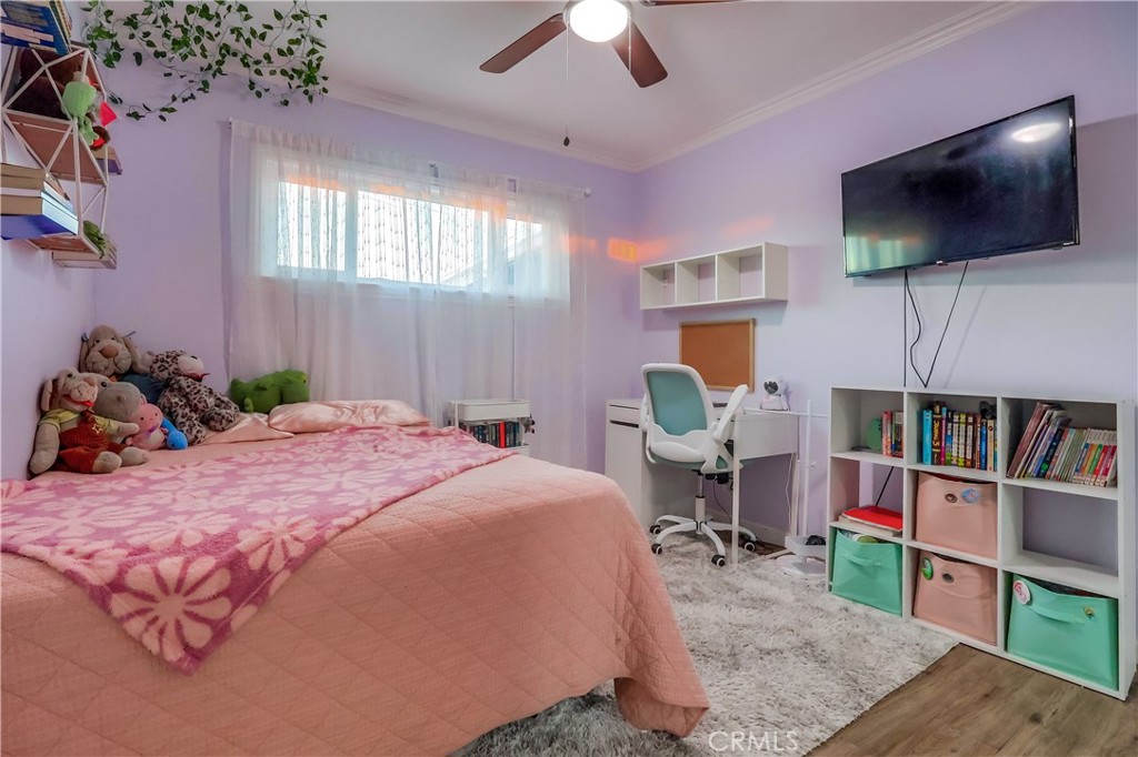 10937 Colima Road Whittier, CA 90604 - Photo 32 of 55 a bed room with a bed a television and a book shelf
