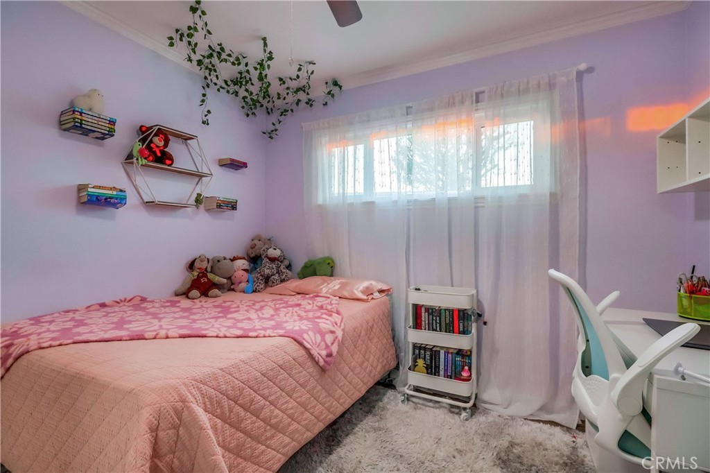 10937 Colima Road Whittier, CA 90604 - Photo 33 of 55 a bedroom with a bed and a chandelier