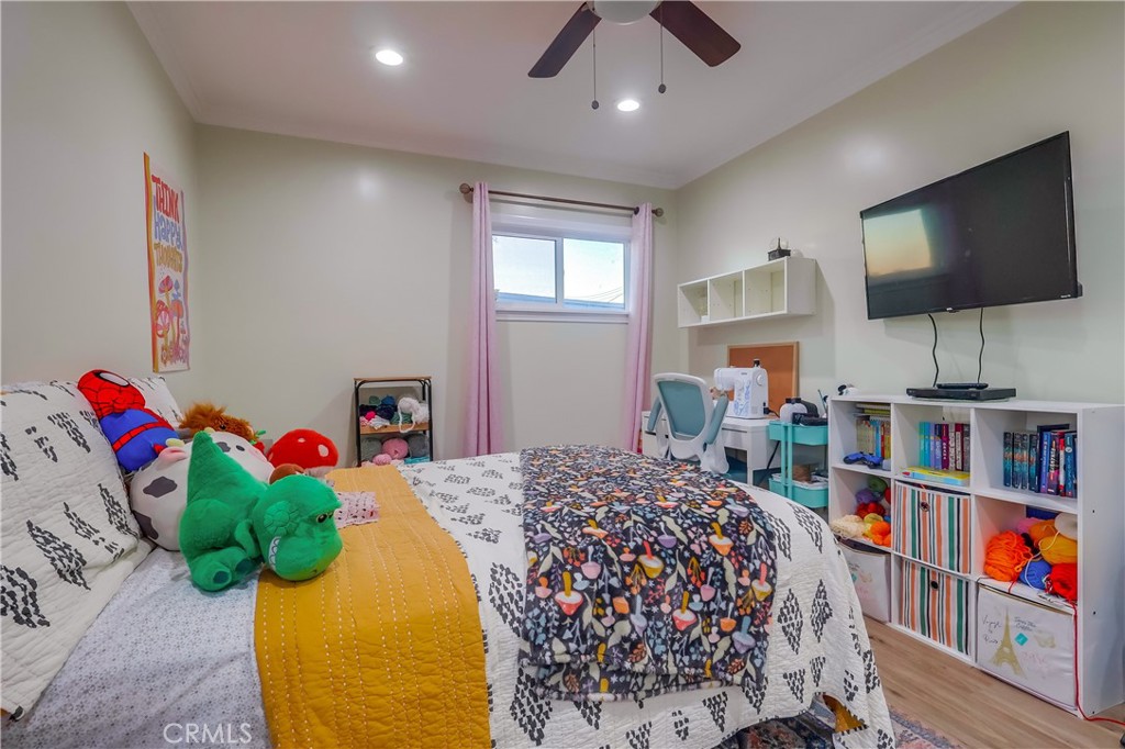 10937 Colima Road Whittier, CA 90604 - Photo 36 of 55 a bedroom with a bed furniture and a flat screen tv