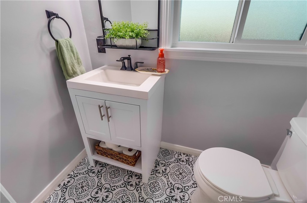 10937 Colima Road Whittier, CA 90604 - Photo 39 of 55 a bathroom with a sink a toilet and mirror
