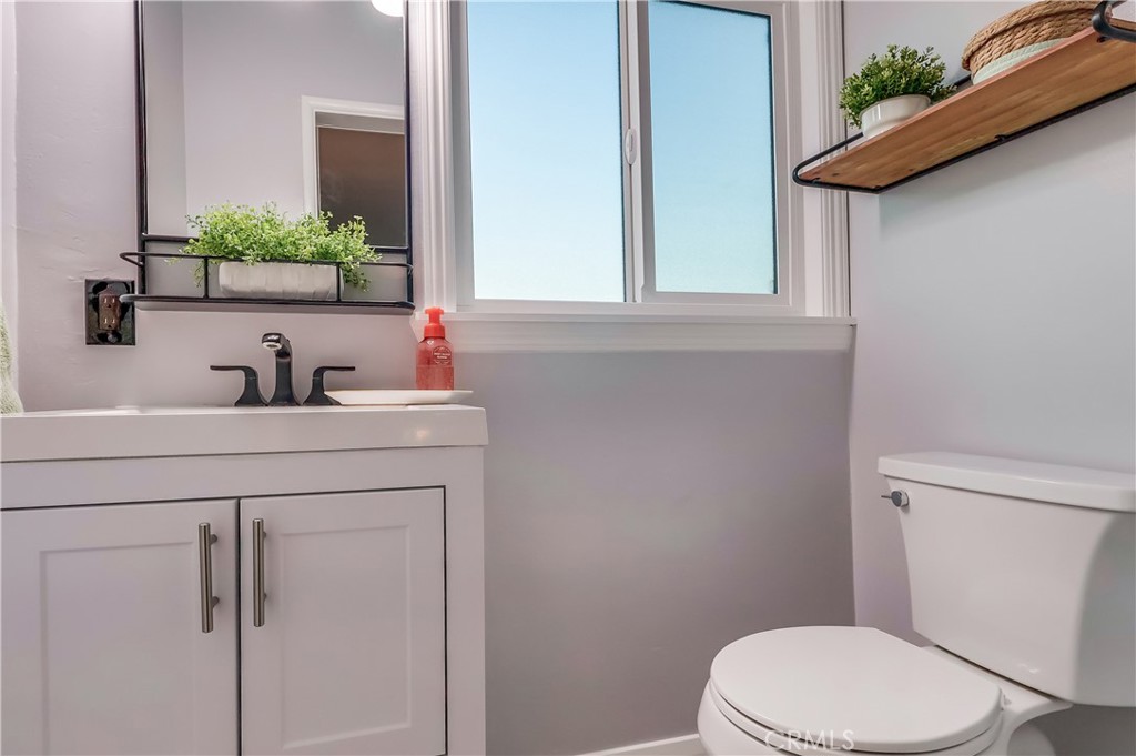 10937 Colima Road Whittier, CA 90604 - Photo 40 of 55 a bathroom with a toilet sink and mirror