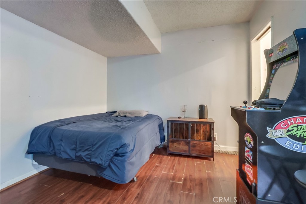 10937 Colima Road Whittier, CA 90604 - Photo 43 of 55 a bedroom with a bed and wooden floor