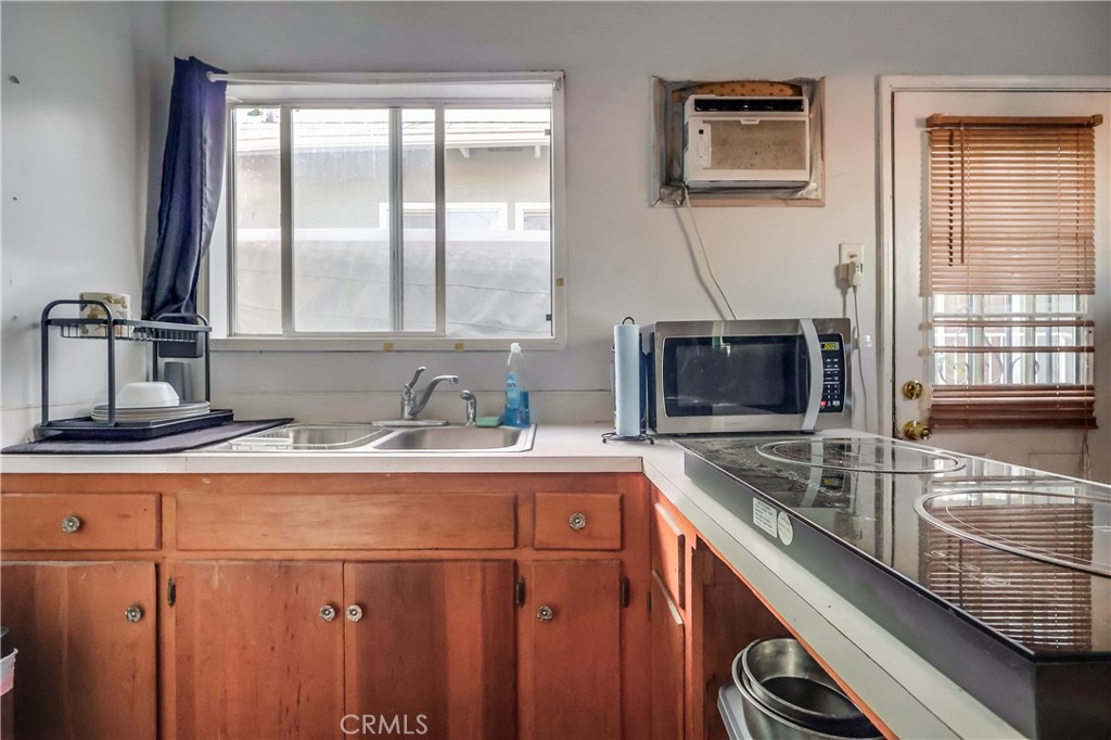 10937 Colima Road Whittier, CA 90604 - Photo 47 of 55 a kitchen with stainless steel appliances granite countertop a sink and a microwave