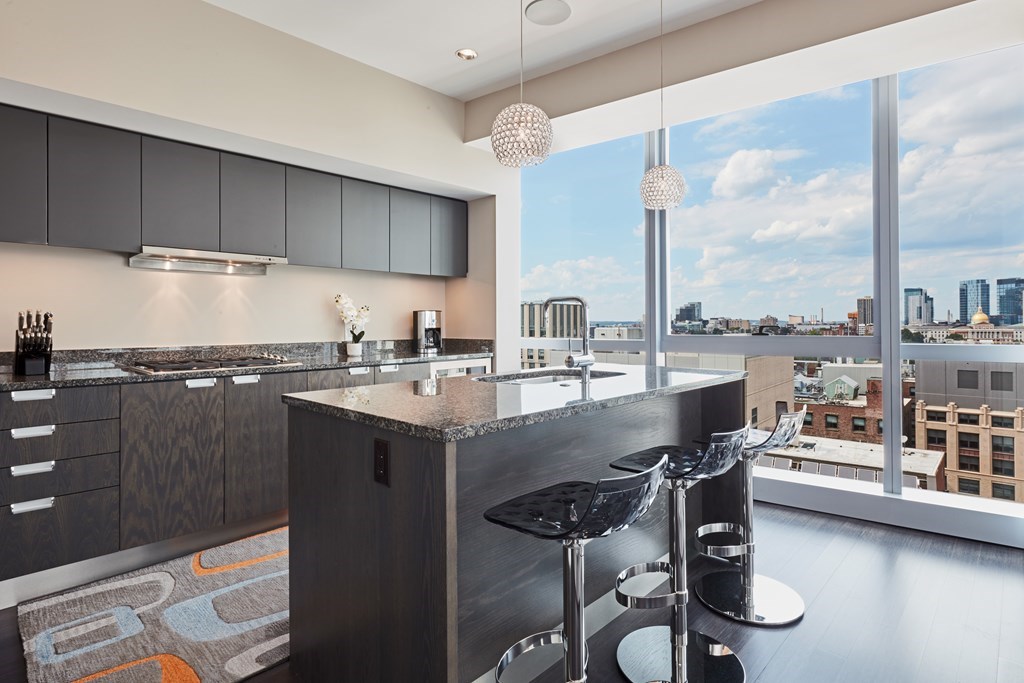 110 Stuart Street, Unit 18G Boston, MA 02116 - Photo 6 of 21 a kitchen with a table chairs stove and cabinets