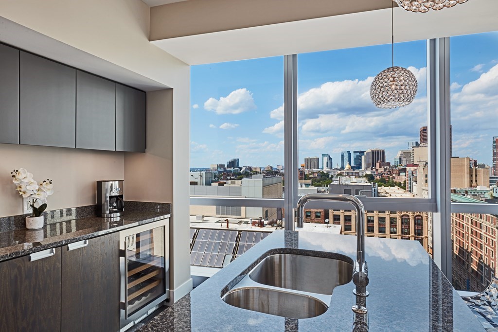 110 Stuart Street, Unit 18G Boston, MA 02116 - Photo 7 of 21 a kitchen with a sink a counter top space and cabinets