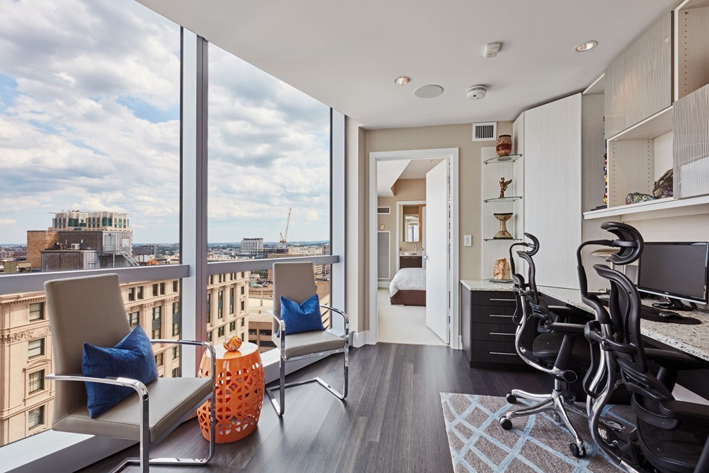 110 Stuart Street, Unit 18G Boston, MA 02116 - Photo 8 of 21 a living room with furniture a flat screen tv and a floor to ceiling window