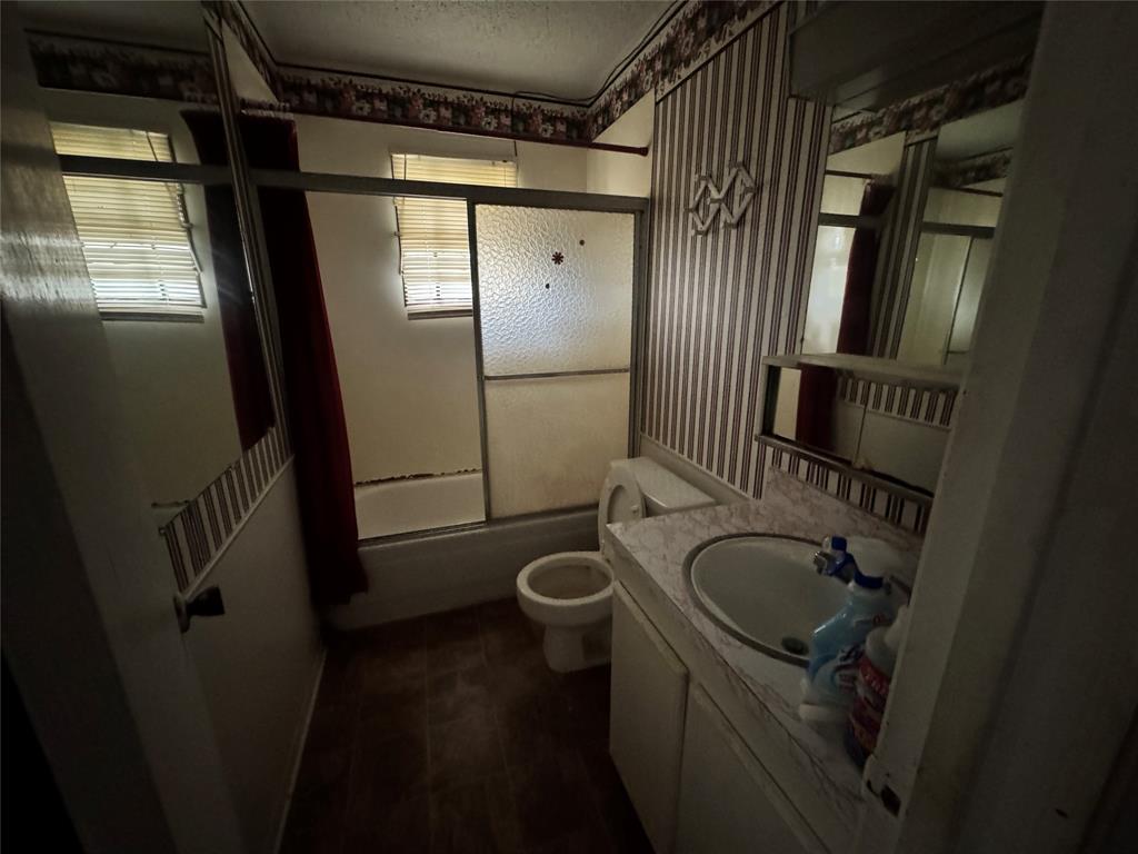 3909 Smothers Road Caney City, TX 75148 - Photo 25 of 35 a bathroom with a granite countertop sink toilet and shower