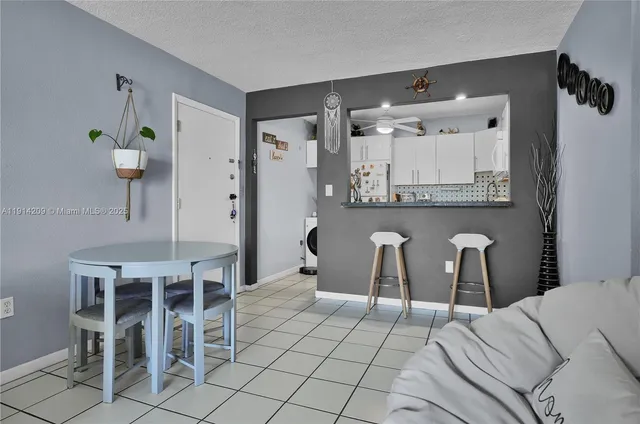 a large white kitchen with a table and chairs