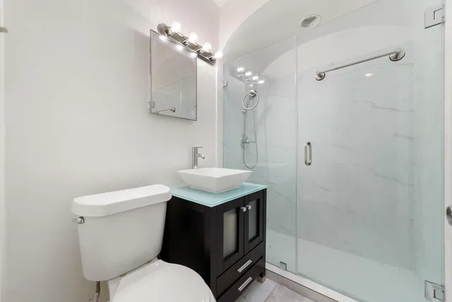 a bathroom with a sink toilet and shower