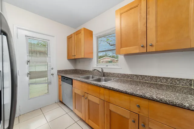a kitchen with granite countertop a sink and a window