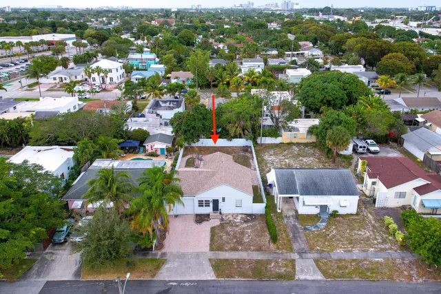an aerial view of residential houses with outdoor space and parking