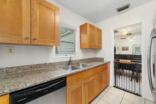 a kitchen with granite countertop a sink and cabinets
