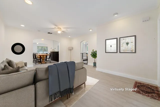 a living room with furniture ceiling fan and a rug