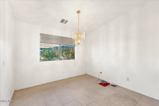 an empty room with a window and ceiling fan