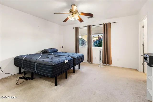 a living room with a table chairs and a chandelier
