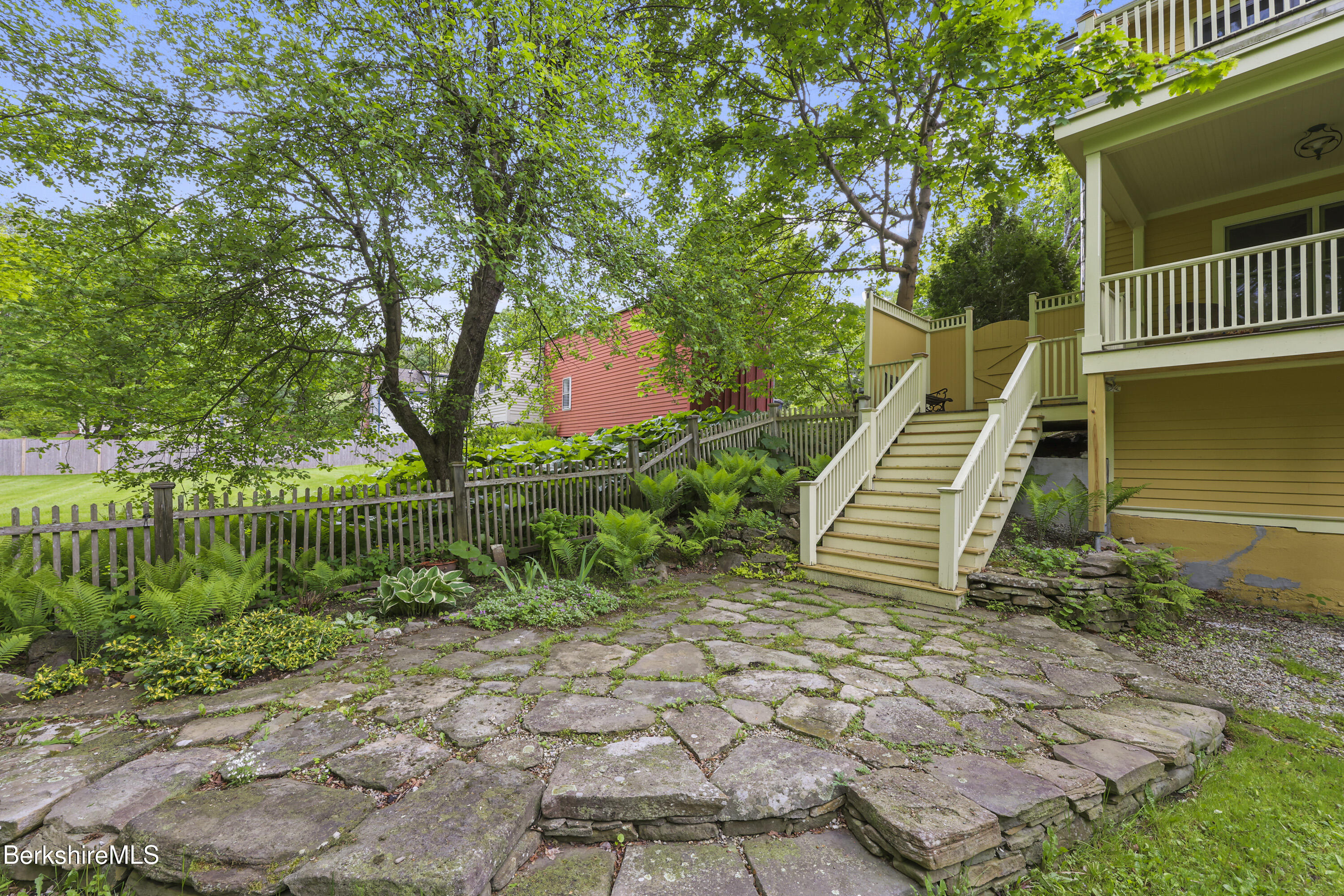 5 Stockbridge Road West Stockbridge, MA 01266 - Photo 7 of 60 a view of a chair and table with wooden floor and fence