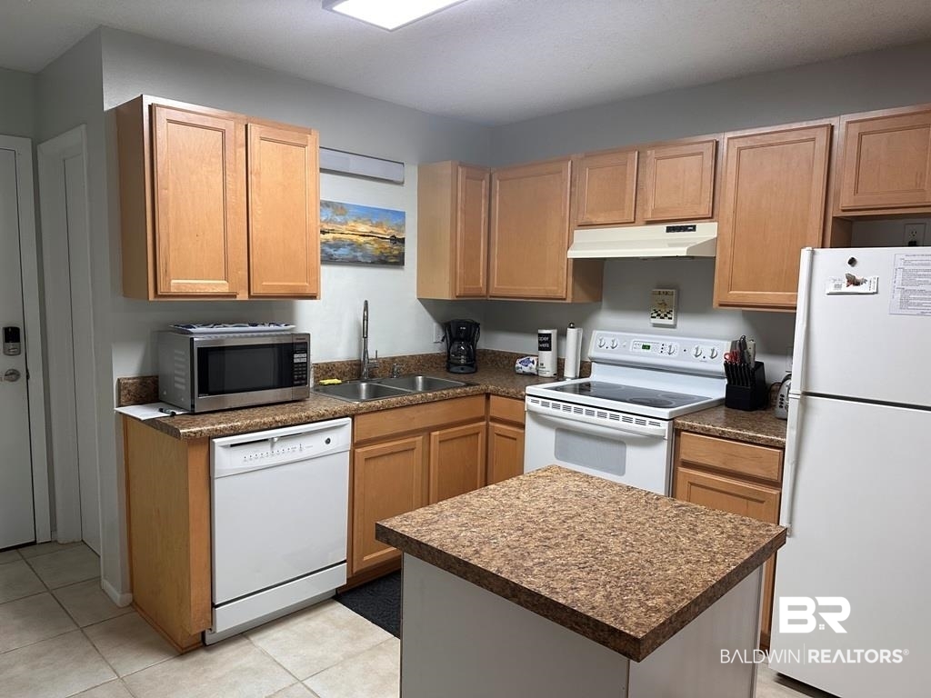 400 Plantation Road, Unit 1113 Gulf Shores, AL 36542 - Photo 3 of 26 Kitchen with sink, white appliances, and light tile patterned floors