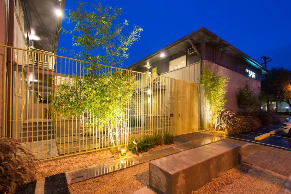 a view of an chairs and chandelier in the balcony
