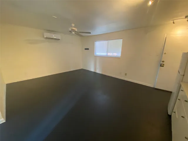 an empty room with a wooden floor and a window