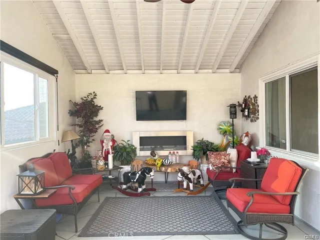 a living room with furniture a fireplace and a potted plant