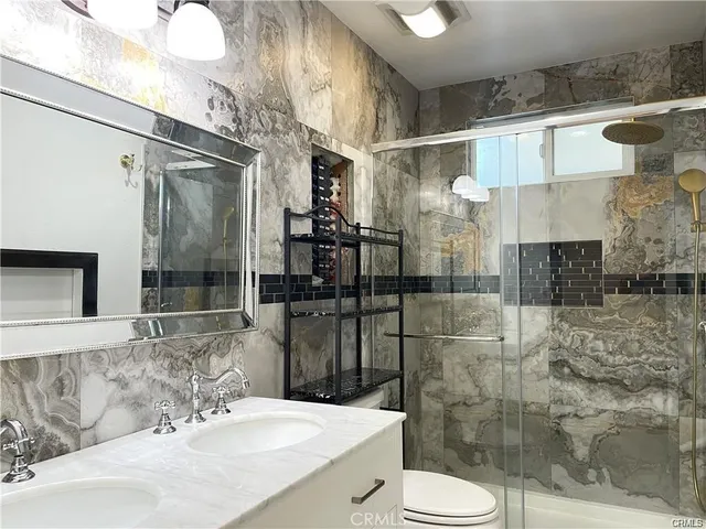 a bathroom with a sink toilet and shower