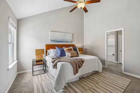 a bedroom with a bed and a chandelier