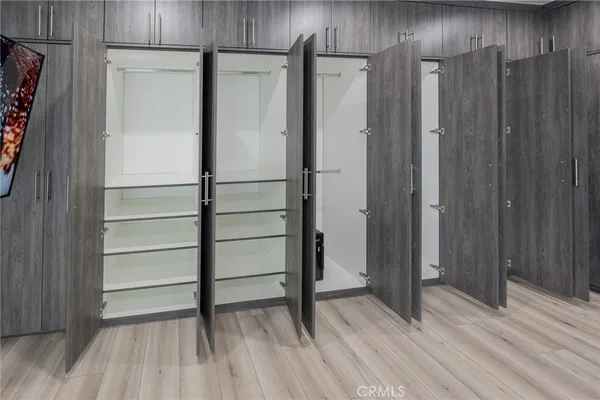 a view of walk in closet with empty racks