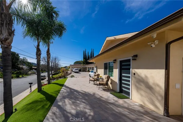 a view of a backyard with plants and a patio