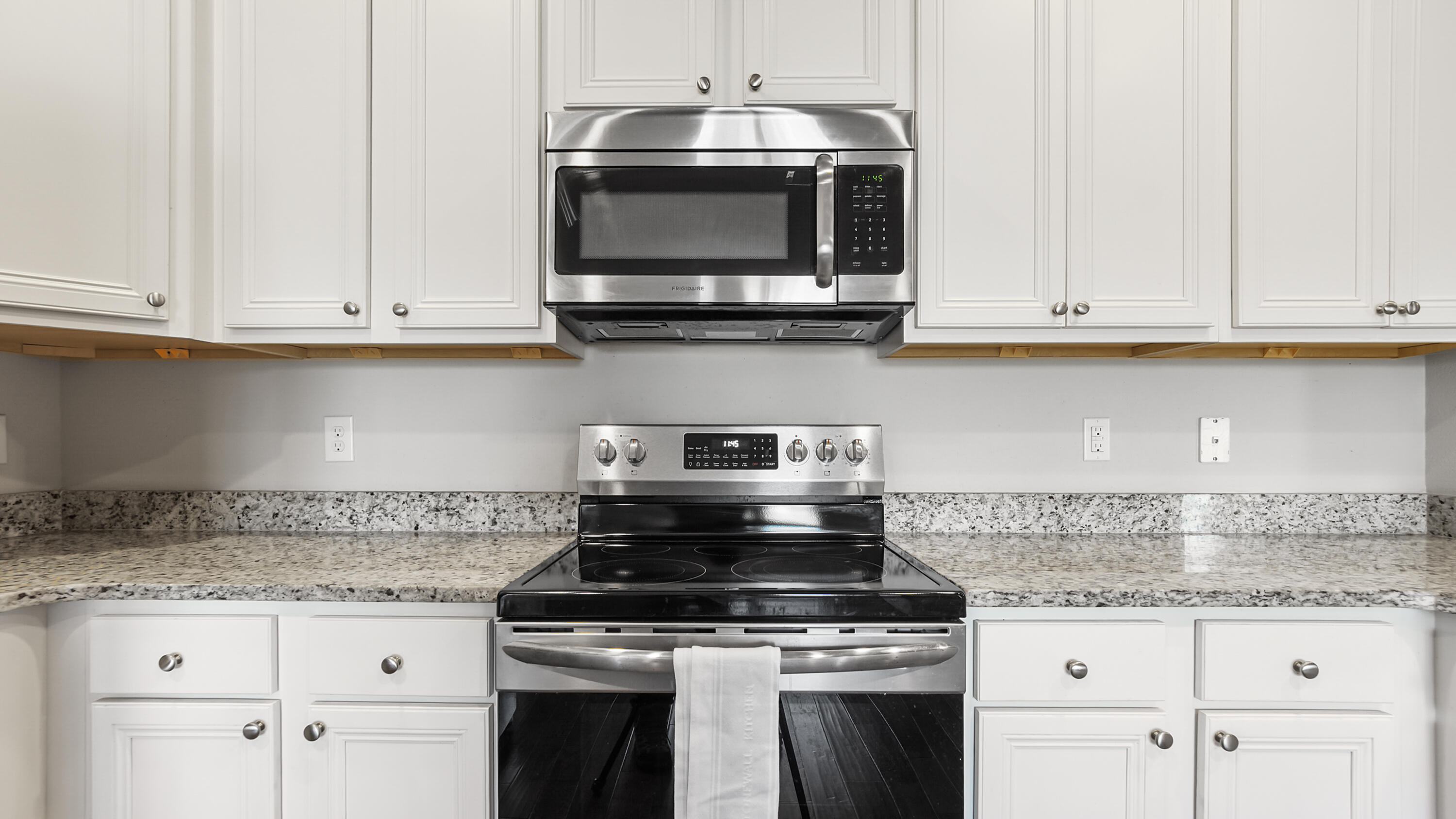 96 Mary Ellen Way Freeport, FL 32439 - Photo 16 of 69 a kitchen with granite countertop white cabinets and appliances