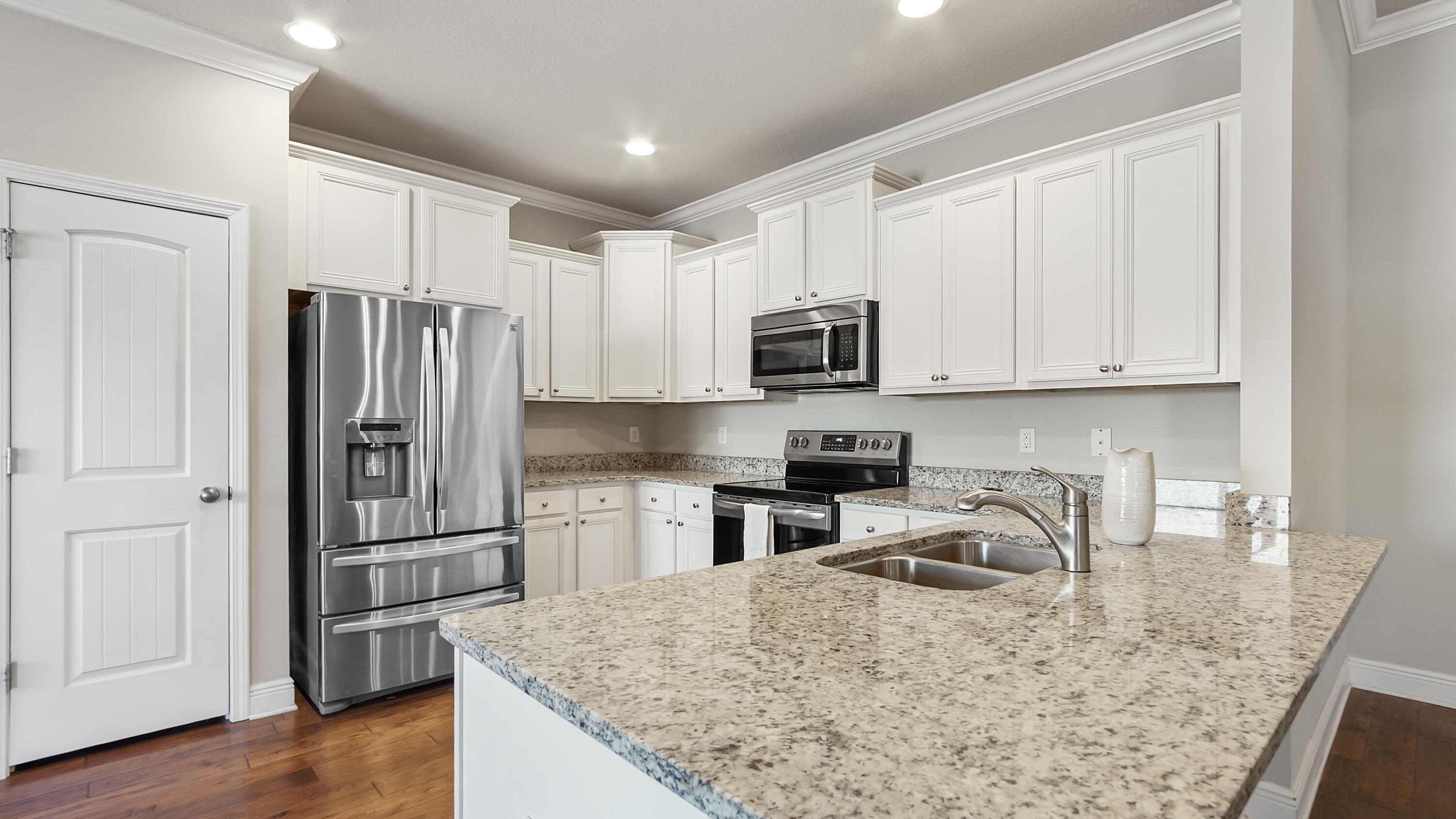 96 Mary Ellen Way Freeport, FL 32439 - Photo 3 of 69 a kitchen with stainless steel appliances granite countertop a refrigerator stove microwave and sink