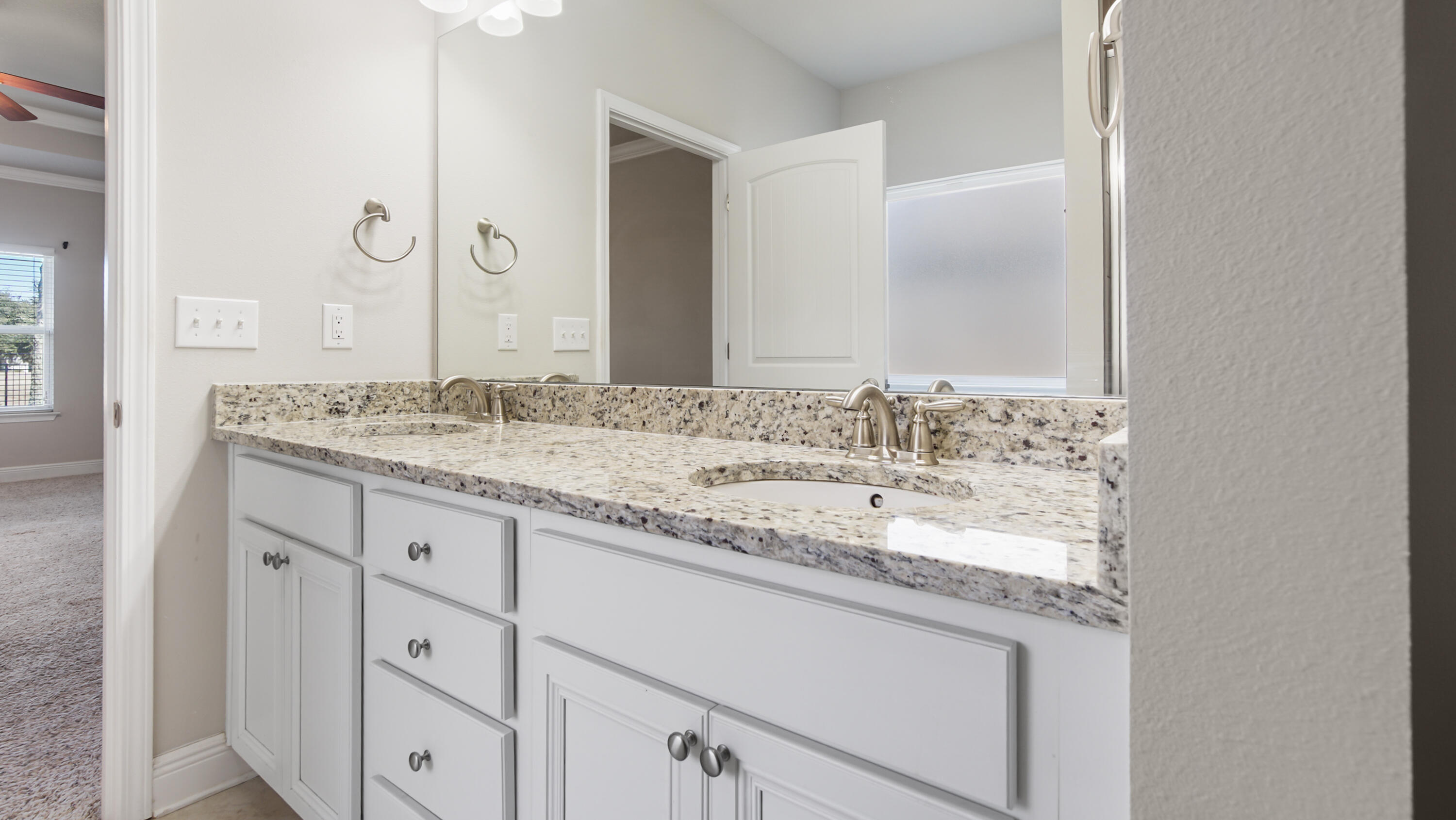 96 Mary Ellen Way Freeport, FL 32439 - Photo 32 of 69 a bathroom with a granite countertop sink and a mirror