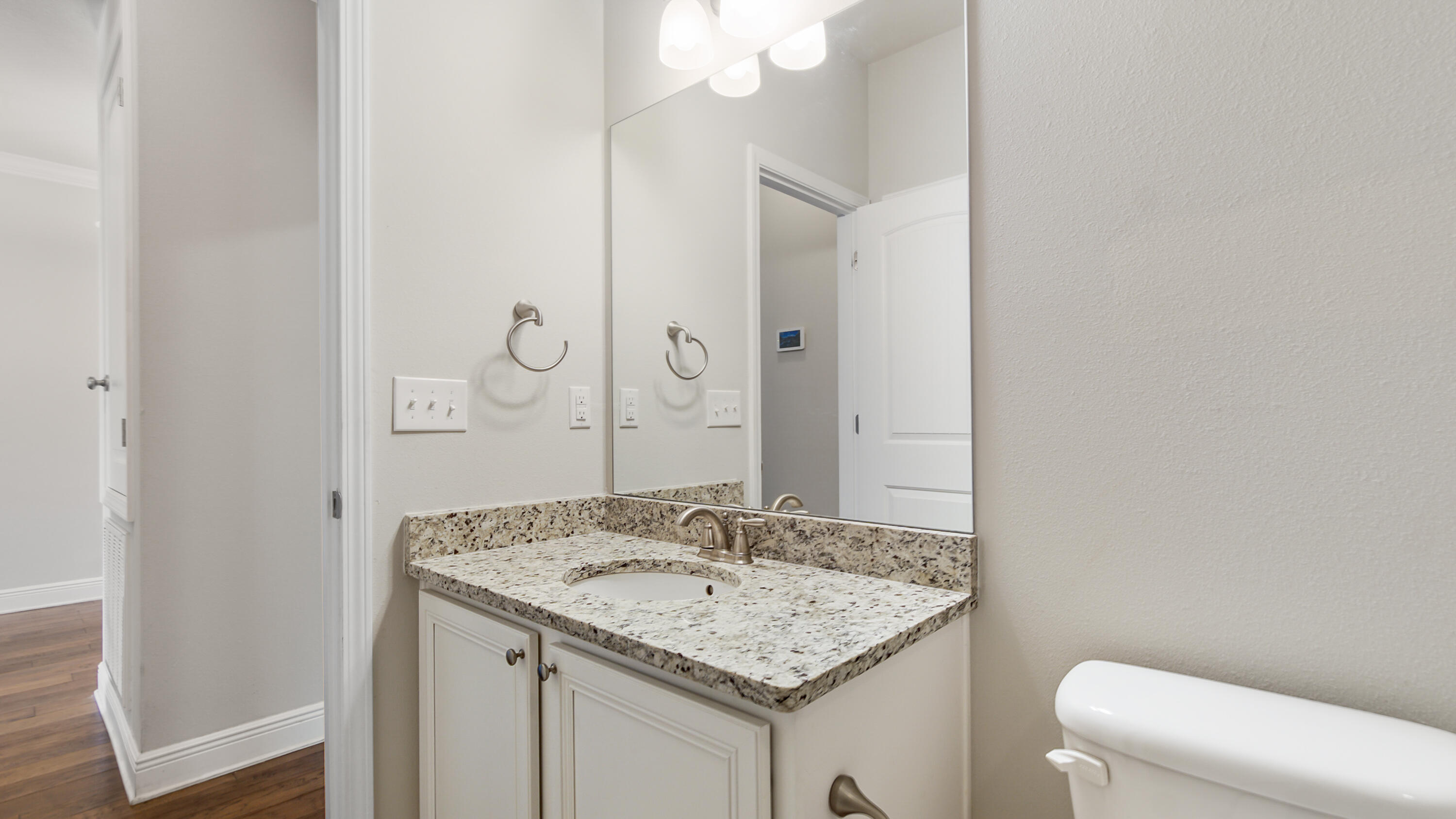 96 Mary Ellen Way Freeport, FL 32439 - Photo 41 of 69 a bathroom with a granite countertop sink and a toilet