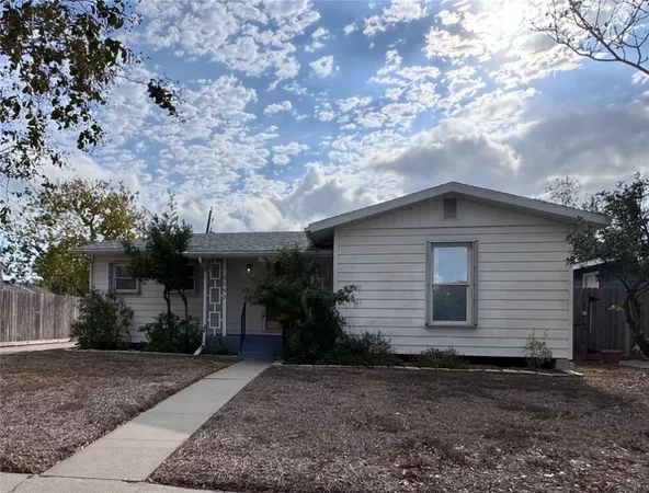 a house with a tree in the background