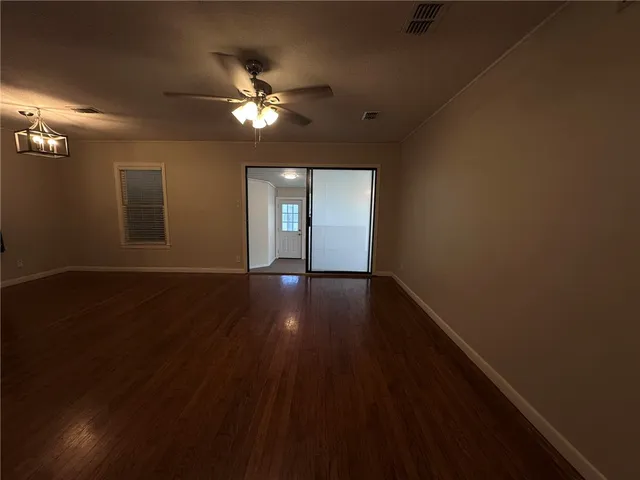 a view of a livingroom with hardwood floor and a ceiling fan