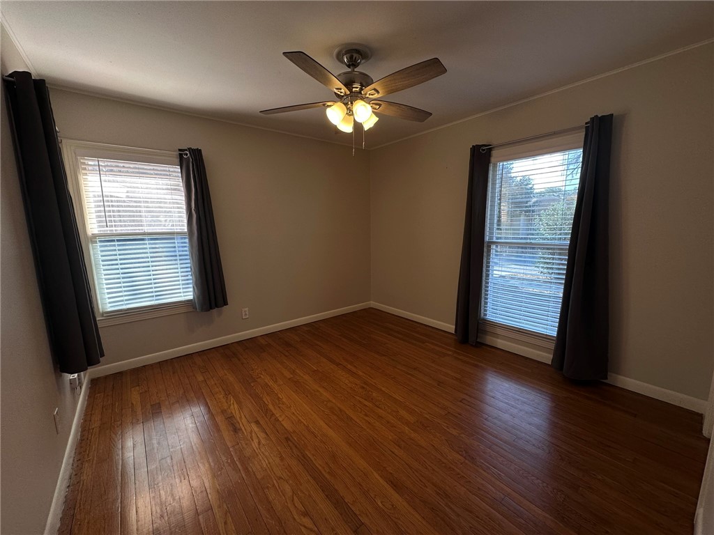 4002 Lowman Street Corpus Christi, TX 78411 - Photo 6 of 18 a view of an empty room with wooden floor and a window