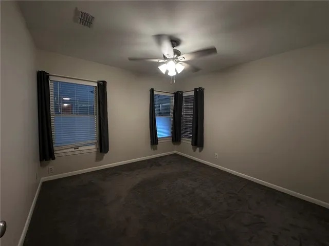 a view of a livingroom with a ceiling fan and window