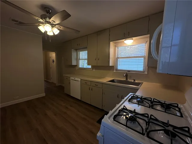 a kitchen with a stove a sink and a microwave