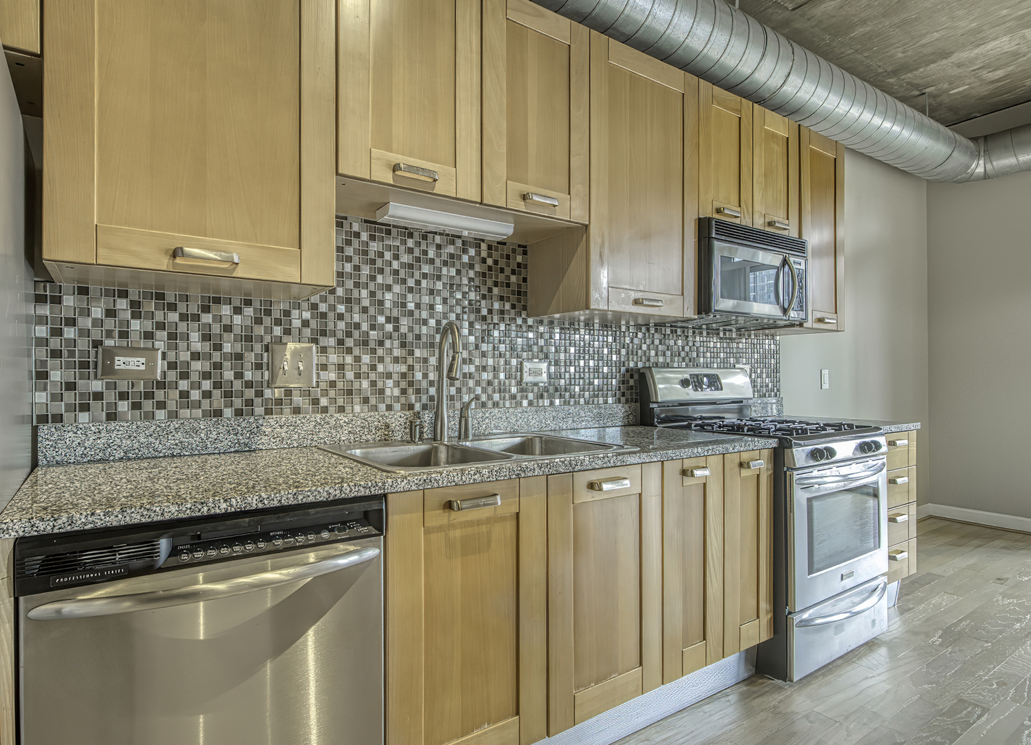 111 South Morgan Street, Unit 518 Chicago, IL 60607 - Photo 10 of 18 a kitchen with stainless steel appliances granite countertop a sink stove and cabinets