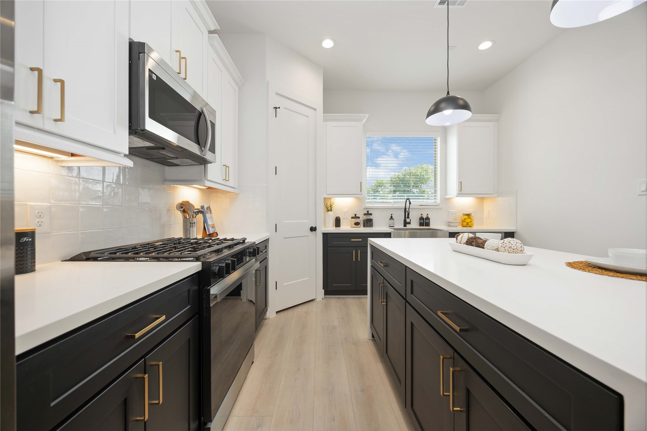 7809 Amelia Road, Unit B Houston, TX 77055 - Photo 14 of 34 a kitchen with stainless steel appliances a stove sink microwave and cabinets