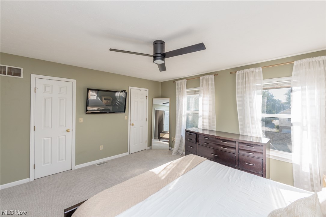 603 Literary Road Cleveland, OH 44113 - Photo 15 of 35 Bedroom with light carpet, multiple windows, and ceiling fan