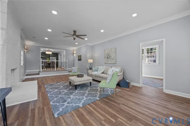 a view of a dining room with furniture large window a chandelier and wooden floor